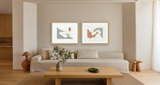 Coastal Silhouette No. 1 and No. 2 in oak frames hung as a pair 18 cm above a linen sofa, 6 cm apart